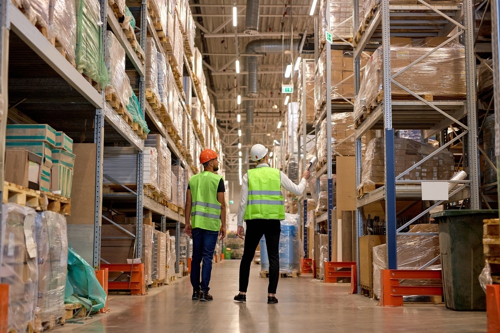 manager and worker discussing warehouse racking layout